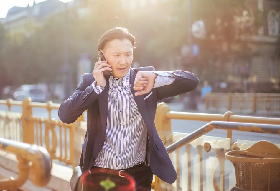 Business person checking his watch.